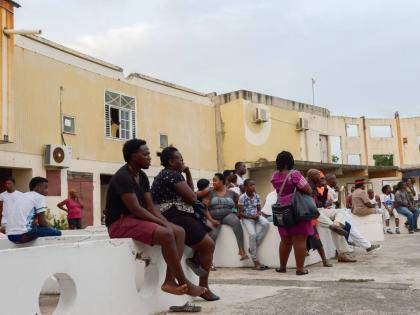 
Residents of Trench Town gather in the old Ambassador Theatre during a  community meeting.