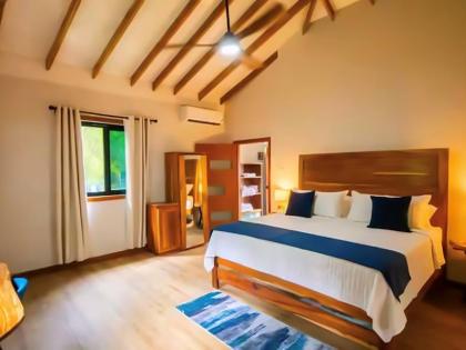 The cottage’s serene bedroom offers a restful retreat, with natural surroundings adding to the sense of tranquillity.