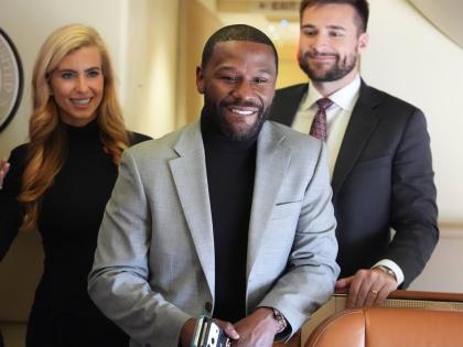 Floyd Mayweather, Jr., stands with White House press secretary Katie Zacharia, left, on Air Force One before a campaign rally with President Donald Trump at Laughlin Bullhead International Airport, in Bullhead, Arizona. 