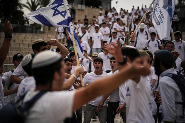 Israelis wave national flags during a march marking Jerusalem Day, an Israeli holiday celebrating the capture of east Jerusalem in the 1967 Middle East war, in Jerusalem’s Old City.