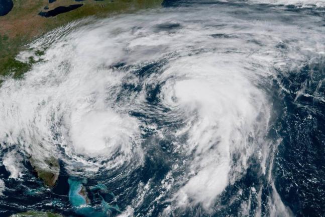 This GOES-19 GeoColor satellite image taken Tuesday, September 30, 2025 and provided by NOAA, shows weather systems in the Atlantic Ocean, Hurricane Imelda, left, and Hurricane Humberto at right. (NOAA via AP)