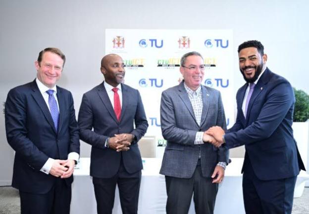 Minister of Transport, Telecommunications and Energy, Daryl Vaz, shakes hands with Caribbean Telecommunications Union (CTU) President, Senator Dominic Smith, during a CTU ICT Week 2025 press briefing on September 29. Others (from left) are Chief Executive 