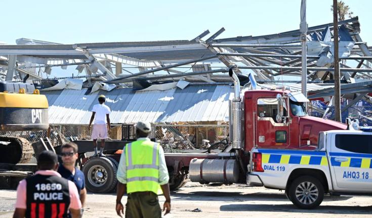The police in St Elizabeth overlook recovery efforts in Black River in the aftermath of Hurricane Melissa.