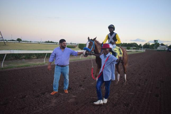 WE JAMMIN, with Omar Walker in the saddle, is flanked by trainer Peter-John Parsard (left) and groom Frank Spencer after capturing the Wayne DaCosta OD Two-year-old Stakes over a mile at Caymanas Park December 26, 2025.