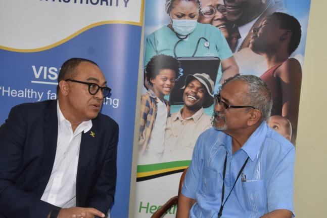 Minister of Health and Wellness Dr Christopher Tufton (left) and clinical coordinator, Western Regional Health Authority, Dr Delroy Fray, converse during a press briefing at the WRHA offices in Montego Freeport on Thursday. 