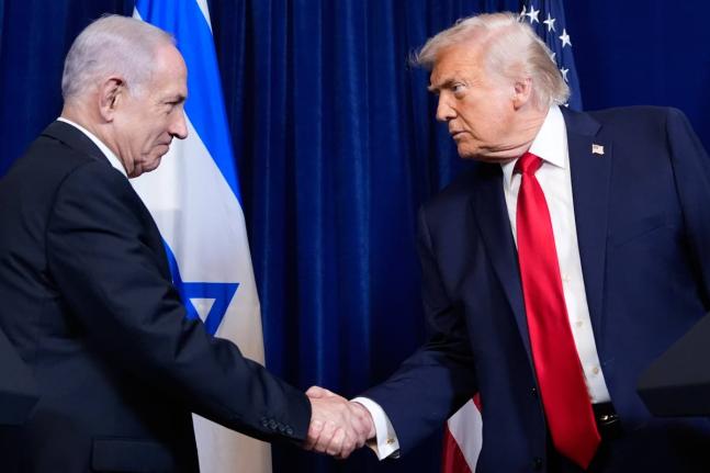 President Donald Trump shakes hands with Israel’s Prime Minister Benjamin Netanyahu during a news conference at Mar-a-Lago, in December 2025 in Palm Beach, Florida. 
