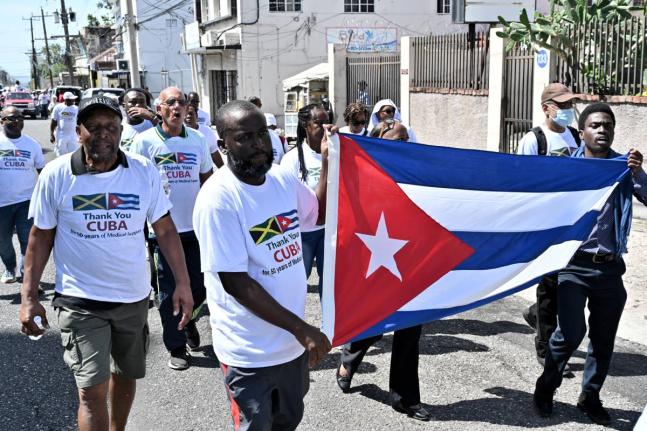 Supporters of Cuban medical professionals participate in the ‘Gratitude Walk’ to show gratitude and appreciation to the Cuban people for their 50 years of medical support to the Jamaican people. The group walked from Hanover Street to Heroes Circle in 
