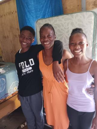 Natalee Watson (centre) and the two children who live with her, Ethon Jackson and Rosetta Jackson. 