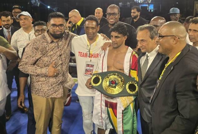 Elton Dharry (centre) poses with his IBO super bantamweight belt. Also pictured at left is Guyana President Irfaan Ali.
