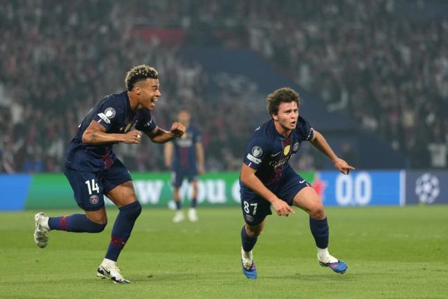 Paris Saint-Germain’s Joao Neves (right) celebrates after scoring his side’s second goal during a Champions League semi-final, first leg, football match against Bayern Munich in Paris yesterday. PSG won 5-4.