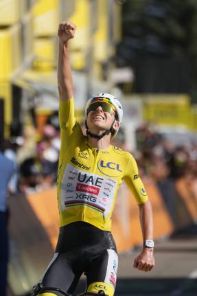 AP 
Slovenia’s Tadej Pogacar, wearing the overall leader’s yellow jersey, crosses the finish line to win the 19th stage of the Tour de France cycling race with start in Gap and finish in Alpe d’Huez, France on Friday.