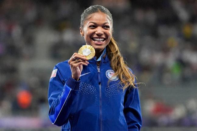 AP 
Gold medallist Gabby Thomas stands on the podium after the women’s 200 metres at the 2024 Summer Olympics, Wednesday, August 7, 2024, in Saint-Denis, France. 