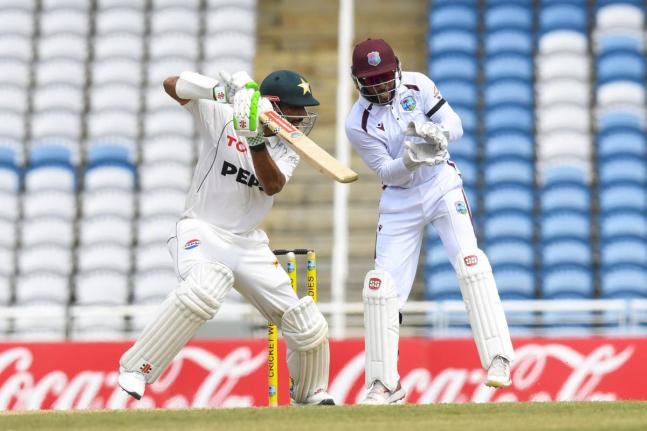 Pakistan batsman Shan Masood plays square of the wicket while West Indies wicketkeeper Shai Hope looks on during action from day two of their Test match at the Brian Lara Cricket Academy in Tarouba, Trinidad yesterday.