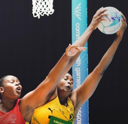 Sunshine Girls goal shooter, Romelda Aiken-George (right), catches a ball during a Commonwealth netball game at the Hydro in Scotland yesterday. Challenging her is Uganda’s Muhameed Haniisha.