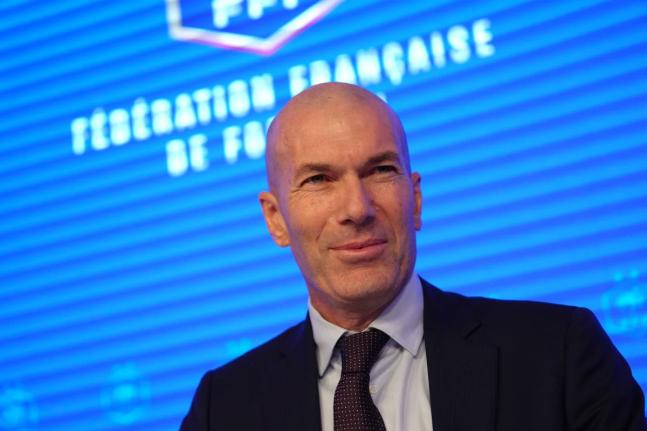 Zinedine Zidane, newly appointed coach of the France national football team, smiles during a media conference at the headquarters of French Football Federation in Paris, yesterday. 