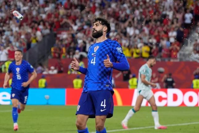 A beer can flies through the air near Croatia’s Josko Gvardiol (4) during the World Cup round-of-32 football match against Portugal in Toronto, Thursday, July 2.