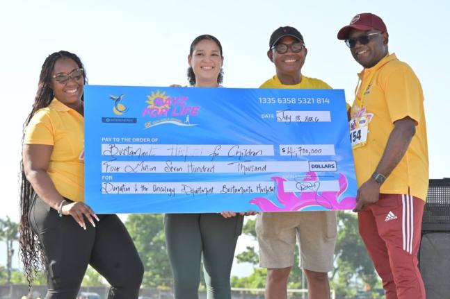 JEP Group President and CEO Dr Wayne McKenzie (left) and Senior Marketing Officer Moya Mullings (right) present a $4.7-million cheque to Bustamante Hospital for Children CEO Anthony Wood (second right) and Dr Kayla Spencer.