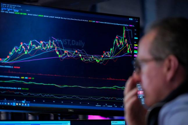 A trader works on the floor of the New York Stock Exchange, Thursday, July 30, 2026, in New York. (AP Photo/Yuki Iwamura)