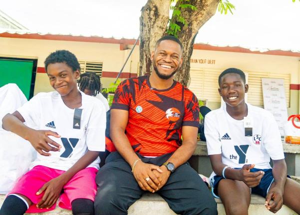Grace & Staff Community Development Foundation Programme Manager Sujae Boswell (centre) shares a light moment with participants at the foundation’s recent Football Bonanza.