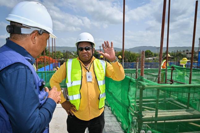 Minister of Health and Wellness, Dr Christopher Tufton (left), in discussion with Regional Director at the Southern Regional Health Authority, Michael Bent during a tour of the expansion project at the May Pen Hospital in Clarendon, on Wednesday.