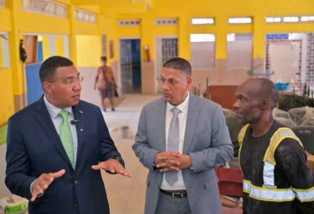 Prime Minister, Dr Andrew Holness (left), converses with Member of Parliament for Kingston Central and State Minister in the Ministry of Labour and Social Security, Donovan Williams (centre), and President of the Parade Gardens Community Development Commit