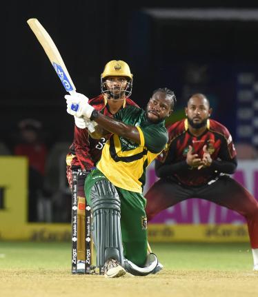 Kirk McKenzie hits a six during his innings of 69 for the Jamaica Kingsmen against the Trinbago Knight Riders at Sabina Park on Saturday night.