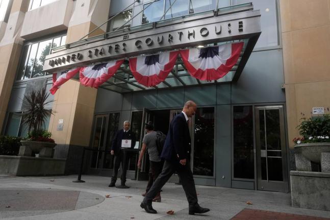 People walk outside of a Federal Courthouse Wednesday, Aug. 12, 2026, in Oakland, Calif. (AP Photo/Jeff Chiu)