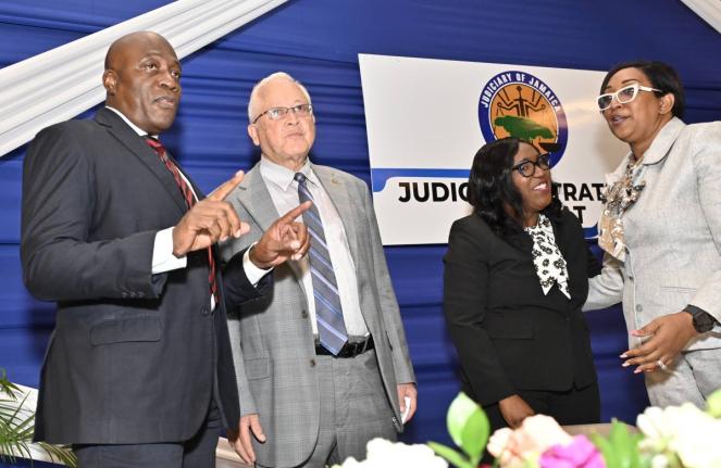 Delroy Chuck (second left), minister of justice and constitutional affairs, speaks with (from left) Chief Justice Bryan Sykes; Tricia Cameron-Anglin, director/ CEO of Court Administration Division; and Justice Simone Wolfe Reece, senior puisne judge of the