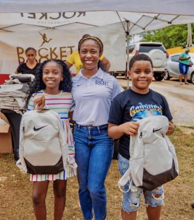 Shelly-Ann Fraser-Pryce (centre), founder and chairwoman of the Pocket Rocket Foundation, pauses for a photo with Jahvena Eaton (left) and Antwan Ellis during the foundation’s annual back-to-school treat, held on Monday, August 10, in Ewarton, St Catheri