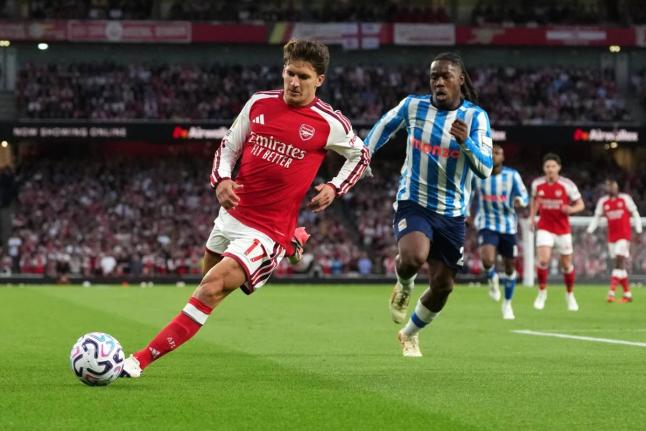 Arsenal’s Christos Tzolis runs with the ball followed by Coventry City’s Brandon Thomas-Asante during the English Premier League  match between Arsenal and Coventry City in London yesterday.