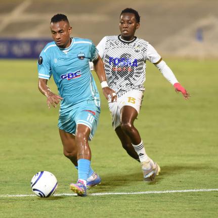 Dwayne Allen (right) of Cavalier moves to challenge Sebastian Ramos  of Salcedo FC during their Concacaf Caribbean Cup football match at the National Stadium on Thursday night. The game ended 0-0.