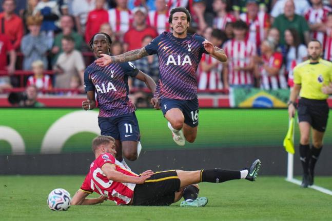Brentford's Kristoffer Ajer, bottom, and Tottenham's Sandro Tonali in action during the English Premier League soccer match between Brentford and Tottenham Hotspur in London, Saturday, Aug. 22, 2026. (AP Photo/Kin Cheung)