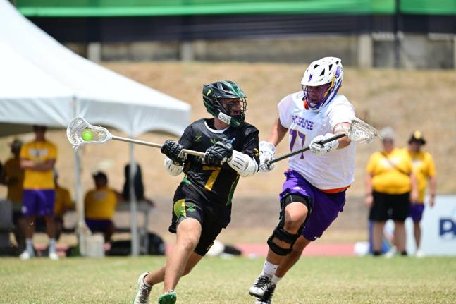Jamaica’s Elias McLaughlin (left) battles with Logan Lee of Haudenosaunee during yesterday’s bronze medal match at the Stadium East field.