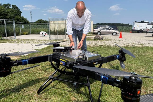 AP
Volatus Aerospace COO Greg Colacitti inspects a heavy-lift drone before a test run on July 13 in Kleinburg, Ontario, Canada.