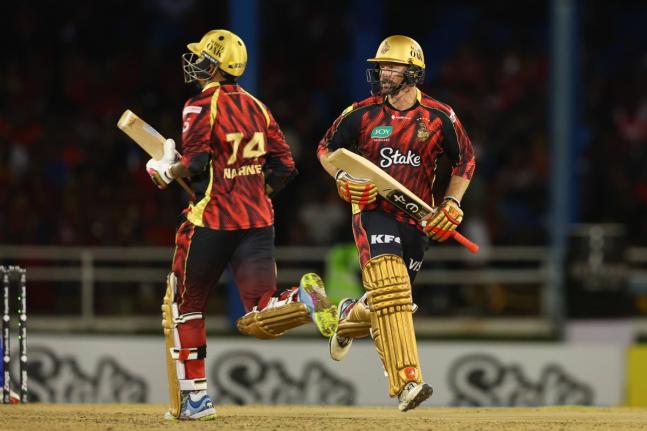 
Trinbago Knight Riders Sunil Narine (left) and Colin Munro go for a run during their Republic Bank Caribbean Premier League match against the Barbados Tridents at Queen’s Park Oval on Friday night.