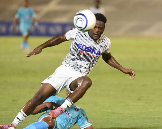 
Rajay Wright of Cavalier FC is brought down by a sliding tackle from Frank Salas of Sacedo FC during their Concacaf Caribbean Cup football match at the National Stadium on August 20.