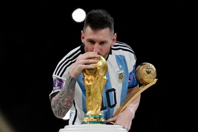 Argentina’s Lionel Messi kisses the trophy after winning the World Cup final match against France in Lusail, Qatar on December 18, 2022. Argentina won 4-2 in a penalty shootout after the match ended tied 3-3. 