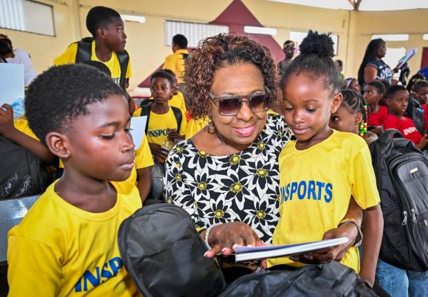 Minister of Culture, Gender, Entertainment and Sport, Olivia Grange, interacts with participants in the INSPORTS Summer Youth Camp 2026, Allan Parkes (left) and Alliandrea Morris, during the camp's recent Closing and Awards Ceremony at Eltham High School i