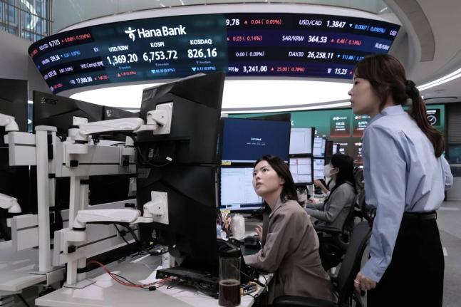 Currency traders watch monitors at the foreign exchange dealing room of the Hana Bank headquarters in Seoul, South Korea, on Tuesday, September 1.  
