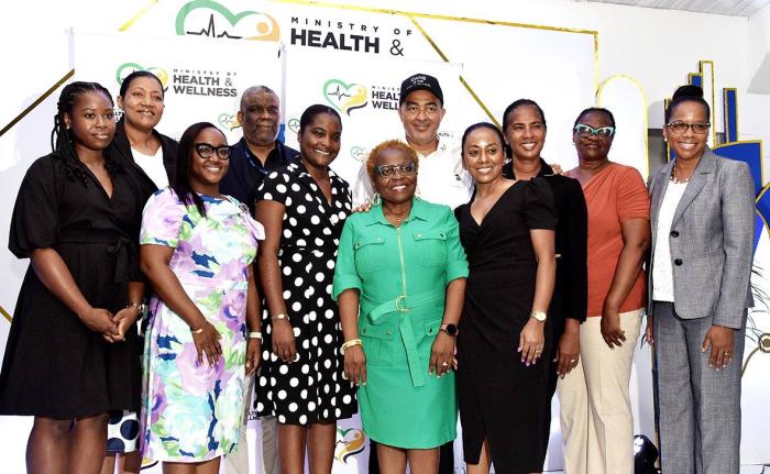 Minister of Health and Wellness, Dr Christopher Tufton (fifth right), along with officials from the ministry, pose with health researchers, during a ceremony for the handover of cheques to five researchers under the Ministry of Health and Wellness’ Resea