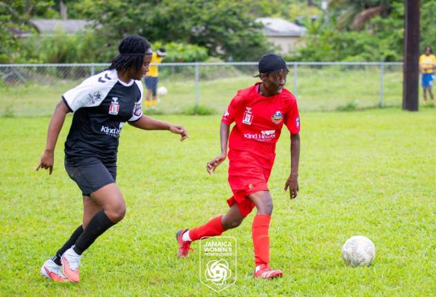 Amoy McKenzie (right) dribbles away from an opponent during a Jamaica Women’s Premier League football match.