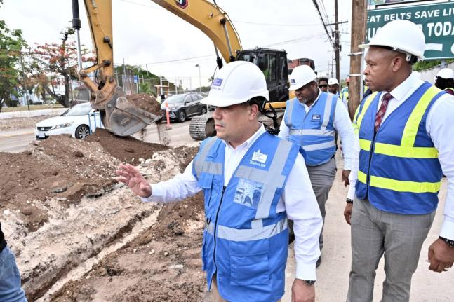 Matthew Samuda (left), Minister of Water, Environment and Climate Change; Kevin Kerr (right), Acting President of the National Water Commission (NWC); and Gary Walters (centre), Senior Project Manager of NWC, tour the Munroe Wellington Pipeline Project on 