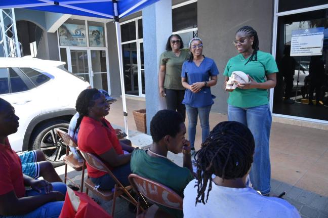 BRIDGING COMMUNITY CARE: Dr. Simone Brady (left), dental surgeon, outlines paediatric oral care to parents and children during D.B.L.’s back-to-school health drive in Portmore on Saturday, August 29. Joining her are visiting physician Dr. Daniella Malco