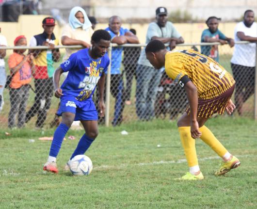 
Clarendon College’s Anthony Reid (left) tries to shake the attentions of Manchester High’s Jequil Forbes during  their ISSA Ben Francis Cup knockout quarter-finals football match at the Manchester playing field yesterday.