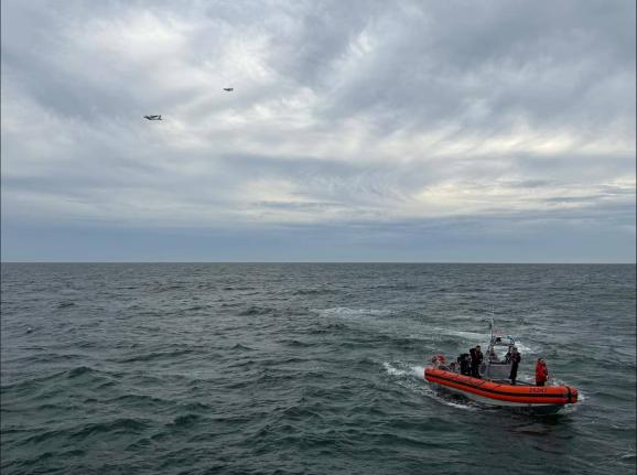 In this photo released by U.S. Coast Guard, crew members search by air and on the water for a Boston-bound air ambulance that vanished off the coast of Nantucket, Massachusetts, on Saturday, Oct. 3, 2026. (U.S. Coast Guard via AP)