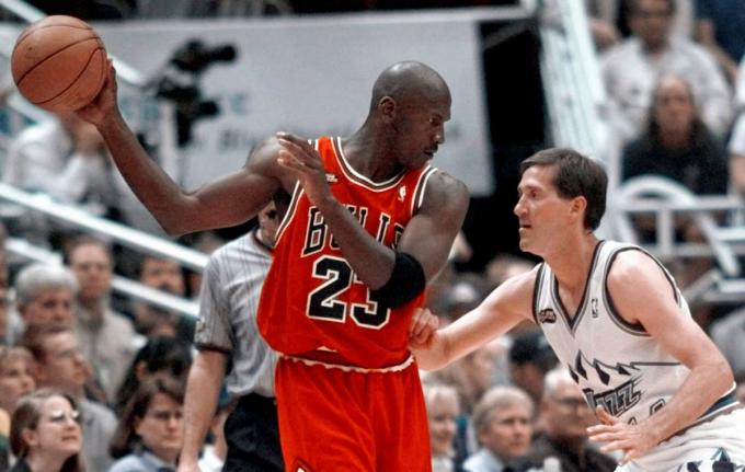 In this file photo, Chicago Bulls' Michael Jordan pulls the ball out of reach of Utah Jazz guard Jeff Hornacek during third quarter action in Game 2 of the NBA Finals in Salt Lake City on June 5, 1998. 