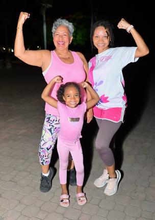 Realtor Elizabeth Oliver (left) joins mother-daughter duo Shari Clarke and little Arya Soman at the second Pink Power weekly workout session.