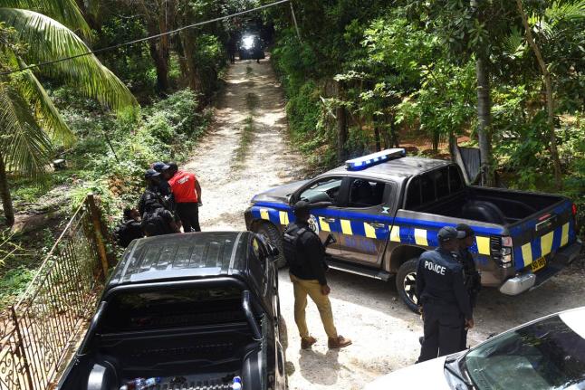 
Members of the Jamaica Constabulary Force (JCF), are seen in the Five Miles area of Sligoville in St Catherine where three of their colleagues were shot and three gunmen killed in an operation.