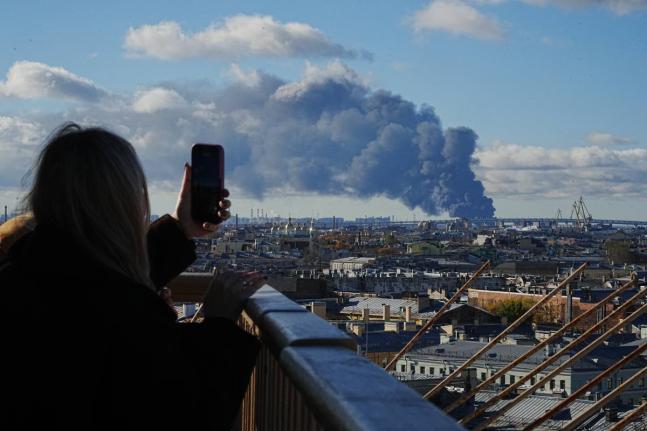 Smoke billows into the sky following Ukrainian drone strikes on an industrial zone in St Petersburg, Russia, on Sunday.