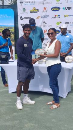 Randy Phillips (left) receives the award for winning the Levy Cheeks Swept Away Clay Court Men’s Open from Shantel Tingling, wealth advisor, NCB Capital Market, Westmoreland Branch.